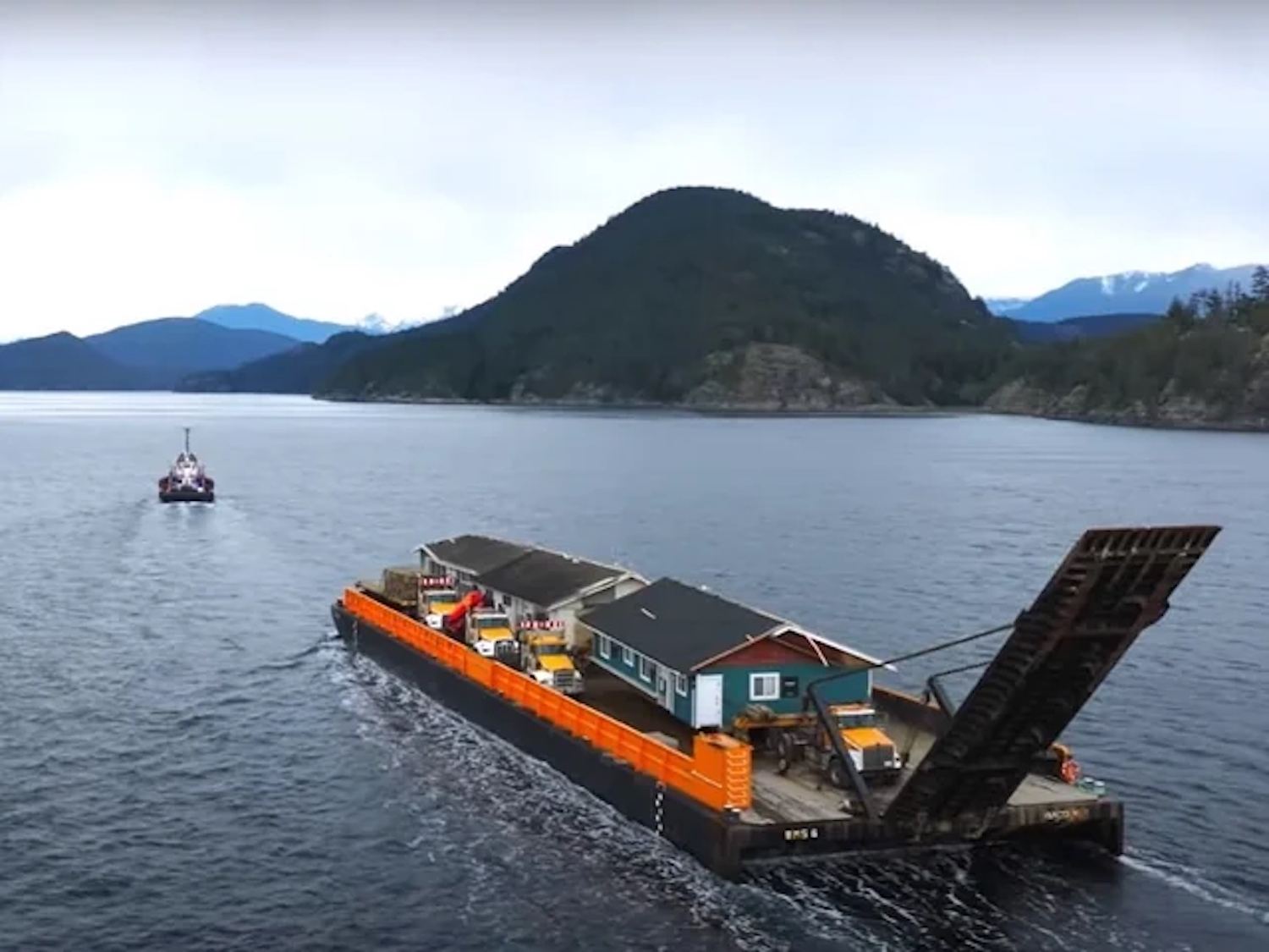 A pre-fab house is on a boat.