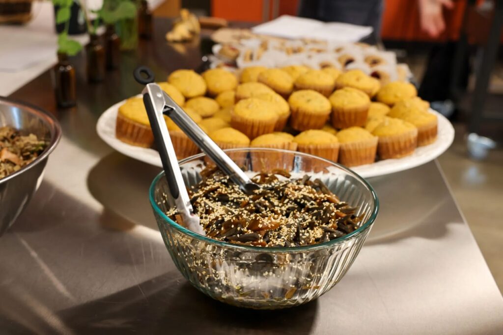 A burdock root salad and goldenrod corn bread are out for class participants to try during a class on wild foods preparation during the Indigenous Food Summit at Portland State University on September 9, 2026. (Photo by Nika Bartoo-Smith, Underscore Native News / ICT)
