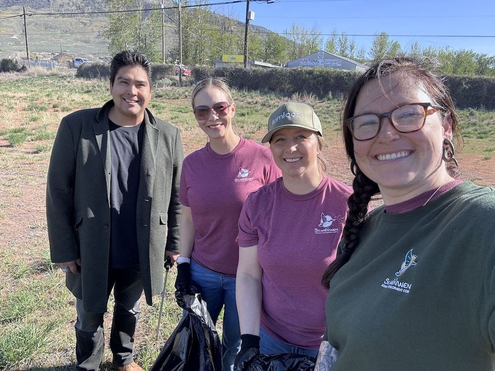 Joshua Gottfriedsen participating in a community cleanup with 3 other people.