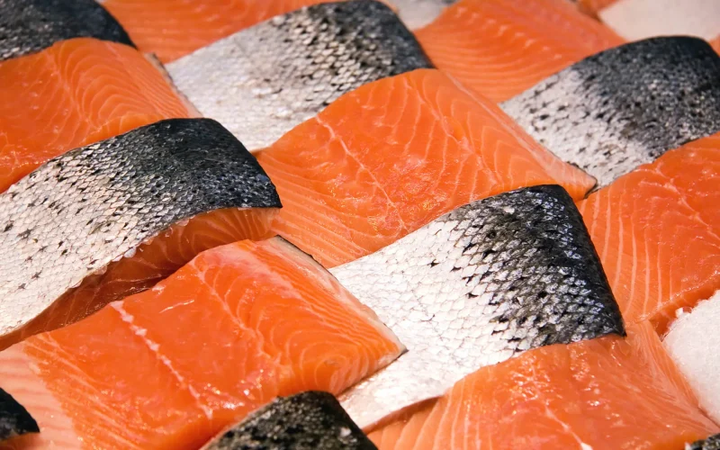 Salmon fillets for sale at a fish market displayed with a patchwork effect